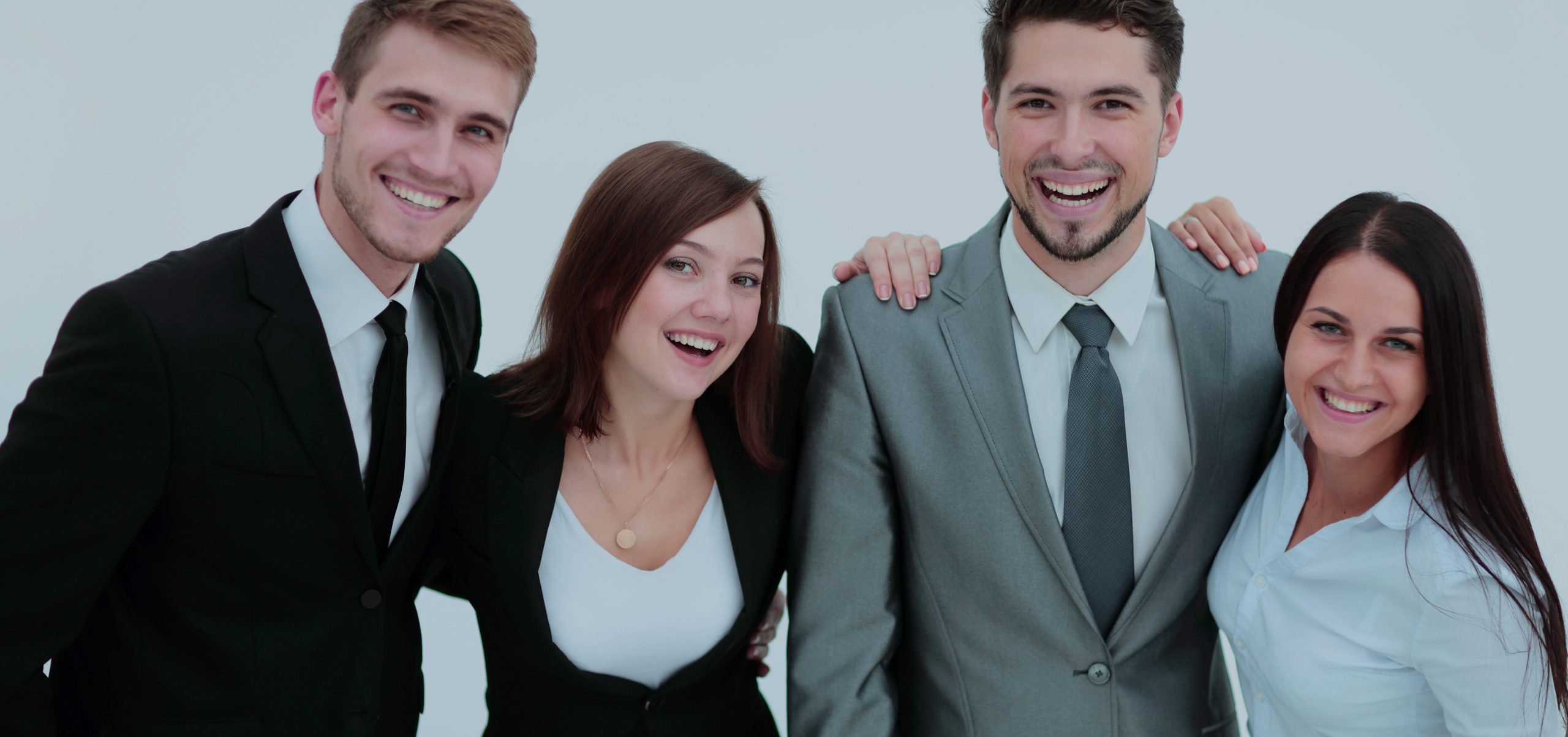 Photo of friendly young businesspeople posing together and smiling.