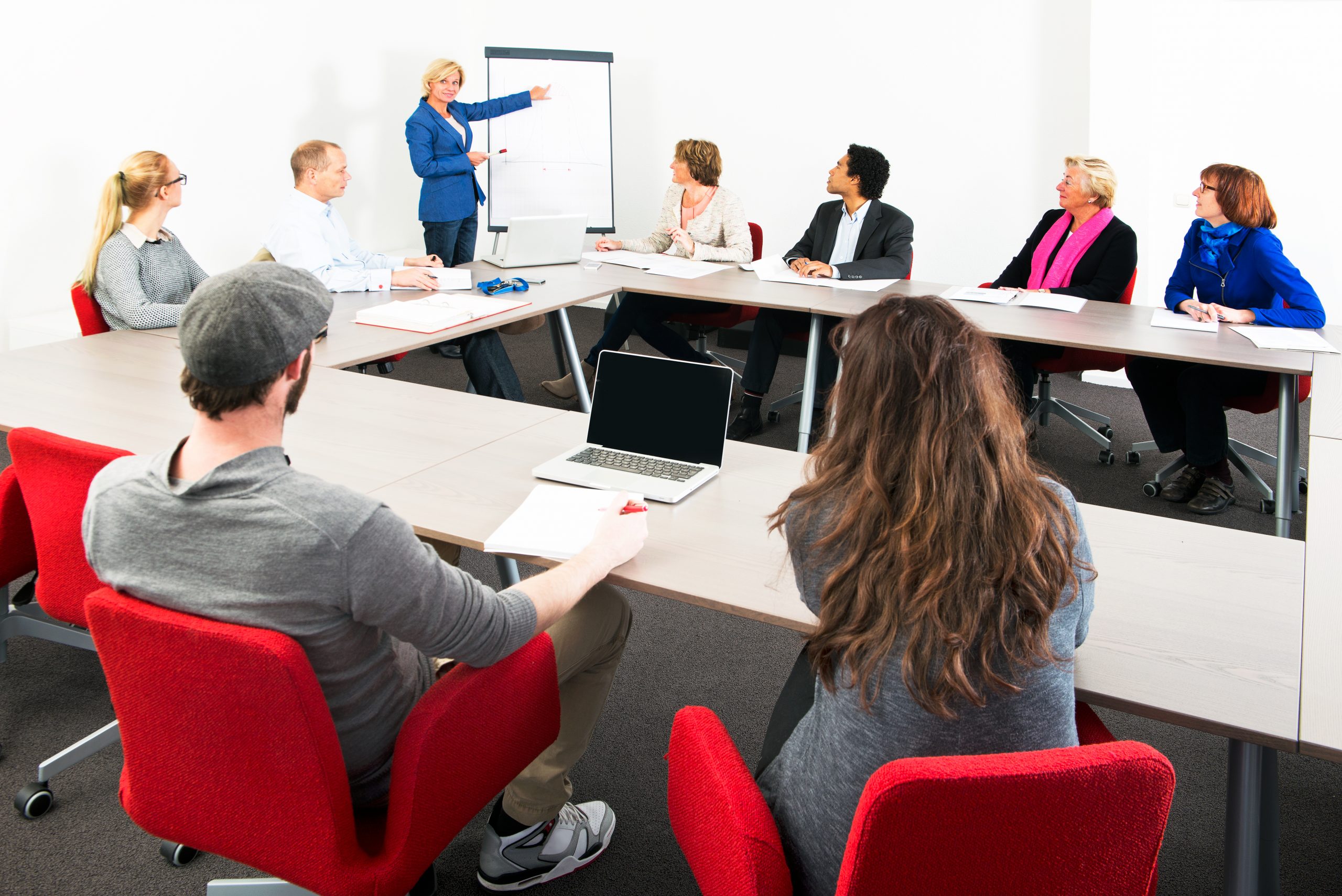 Several businesspeople meeting in a spaceous meeting room for a presentation